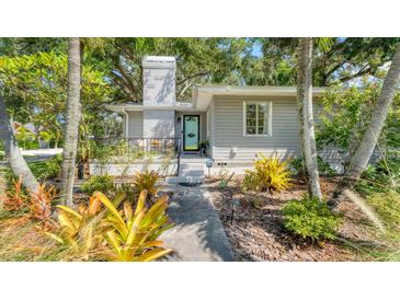 Charming house with landscaped front yard, walkway, and mature trees at 401 28Th W St, Bradenton, FL 34205