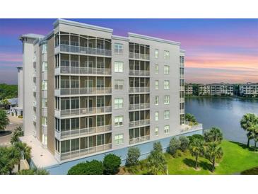 Luxury condo building with lake views at sunset at 10520 Boardwalk Loop # 605, Lakewood Ranch, FL 34202