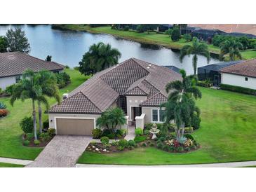 Single-Gathering home with tile roof, landscaping, and a view of a lake at 12663 Fontana Loop, Bradenton, FL 34211