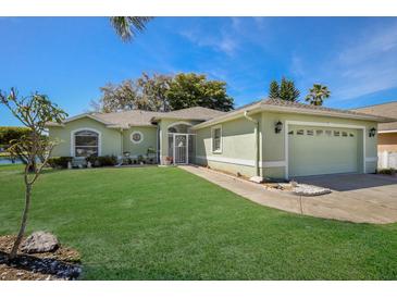 Light green house with a two-car garage at 5018 25Th E St, Bradenton, FL 34203