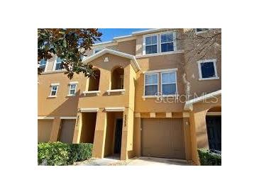 Exterior view of a three-story townhome with two-car garage at 7313 Black Walnut Way, Lakewood Ranch, FL 34202