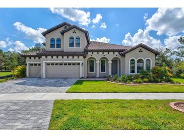 Two-story home with a three-car garage and attractive landscaping at 14607 Swiss Bridge Dr, Lithia, FL 33547
