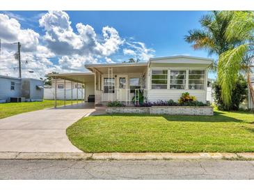 Charming single-story home with a carport and well-maintained lawn at 718 50Th Avenue W Dr, Bradenton, FL 34207