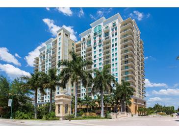 Luxury high-rise building with palm trees and a fountain at 800 N Tamiami Trl # 1412, Sarasota, FL 34236