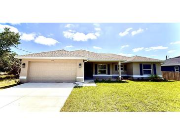 Charming single-story home with a well-manicured lawn, two car garage, and neutral color palette at 2132 Nordendale Blvd, North Port, FL 34288