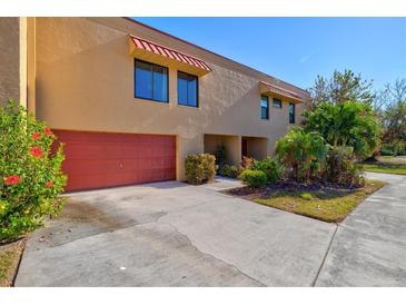 Tan colored condo building with red garage door at 4013 Catalina Dr # 4013, Bradenton, FL 34210