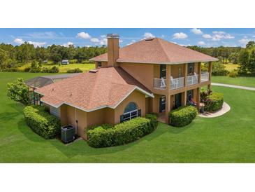 Two-story house with pool and large grassy yard at 7301 221St E St, Bradenton, FL 34211