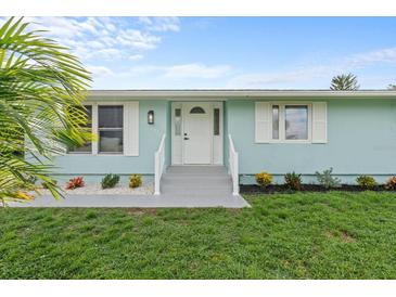 Charming light blue house with white trim and landscaping at 4691 Grobe St, North Port, FL 34287