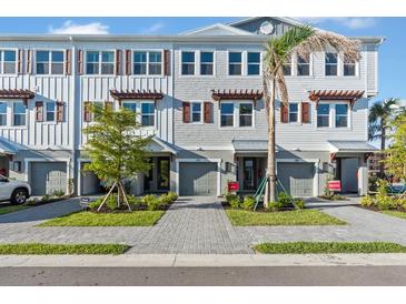 Beautiful townhome exteriors showcasing a modern facade, complemented by well-manicured landscaping and inviting entrances at 1625 Compass Pointe Ct # 105, Punta Gorda, FL 33950