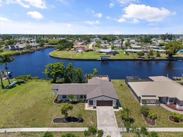 Waterfront home with a spacious yard and scenic views of the canal and neighborhood from above at 6912 Kenwood Dr, North Port, FL 34287