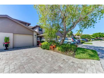 Inviting exterior with a paved driveway and lush landscaping at 1648 Starling Dr # 202, Sarasota, FL 34231