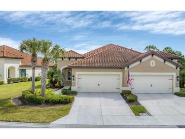 Exterior view of a beautiful two-car garage home with tile roof and landscaping at 317 Acerno Dr, North Venice, FL 34275