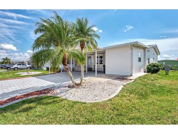 Single-story home with carport and palm trees at 634 Schooner St, North Port, FL 34287