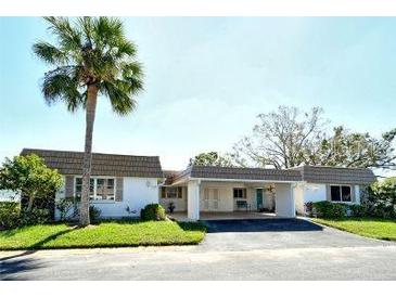 Condo exterior, carport, palm tree at 2020 Riverbluff Pkwy # V329, Sarasota, FL 34231