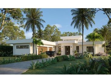 Modern home with a two-car garage, meticulously landscaped yard, and a stylish white facade at 4431 Camino Real, Sarasota, FL 34231