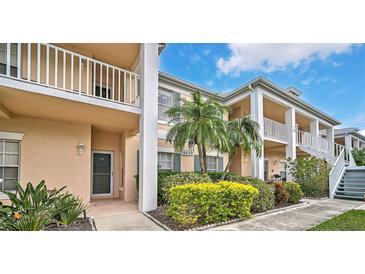 Two-story building with balconies and lush landscaping at 4210 Caddie E Dr # 102, Bradenton, FL 34203