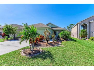 One-story house with green exterior and landscaped yard at 9815 33Rd E Ave, Palmetto, FL 34221