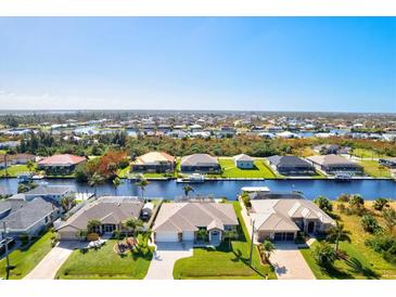 Aerial view of a canal-front community with single-Gathering homes at 15912 Melport Cir, Port Charlotte, FL 33981