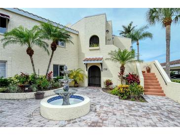 Mediterranean-style building with courtyard fountain, inviting entryway, and lush landscaping at 6101 34Th W St # 15B, Bradenton, FL 34210