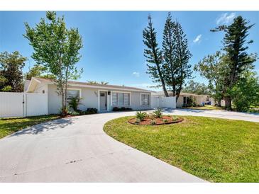 Charming single-story home with a well-manicured lawn and a circular driveway at 1012 Myrtle Ave, Venice, FL 34285