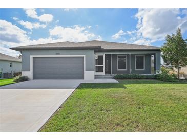 Single story home with gray exterior and screened porch at 11213 Gulfstream Blvd, Port Charlotte, FL 33981