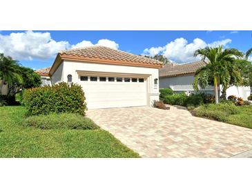 Single-story house with a two-car garage and a well-manicured lawn at 3924 Alamanda Dr, Sarasota, FL 34238
