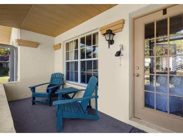 Front porch with two teal Adirondack chairs and a glass front door at 4601 Ulster Ave, North Port, FL 34287