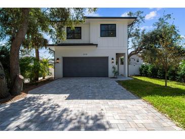 Modern two-story house with gray garage door and landscaping at 2318 Bay St, Sarasota, FL 34237