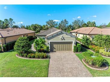 House exterior showcasing a two-car garage and well-manicured landscaping at 5016 Savona Run, Bradenton, FL 34211