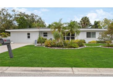 Ranch-style home with attractive landscaping and a well-maintained lawn at 2425 Clematis St, Sarasota, FL 34239