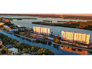 Aerial view of waterfront condos with parking and resort-style amenities at 9397 Midnight Pass Rd # 505, Sarasota, FL 34242