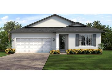 Two-car garage and attractive landscaping at 1699 Sunset Preserve Way, Port Charlotte, FL 33953