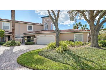 Townhouse with a brick walkway and lush landscaping at 1713 Starling Dr # 1713, Sarasota, FL 34231