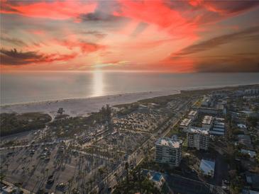 Breathtaking aerial view of beachfront property with colorful sunset sky and ocean views at 1055 Beach Rd # B-302, Sarasota, FL 34242