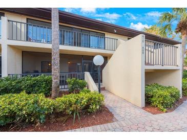 Condo building exterior with landscaped walkway and entrance at 6435 Egret Ln # 409, Bradenton, FL 34210