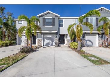 Front view of two-story townhome with gray siding at 8685 Daydream St, Sarasota, FL 34238