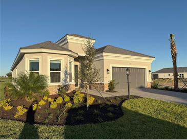 Single-story home with gray garage and landscaped front yard at 15821 San Lazzaro Ave, Bradenton, FL 34211