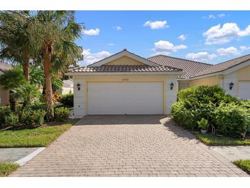 Attached two-car garage with paver driveway and meticulously maintained landscaping adds to the home's curb appeal at 5793 Ithaca Way, Sarasota, FL 34238