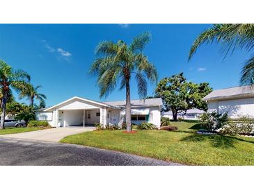 Charming single-story home with well-manicured lawn, mature landscaping, and convenient covered parking at 6006 Hibiscus Dr # 6006, Bradenton, FL 34207