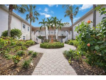 Community courtyard with lush landscaping, fountain, and walking paths at 4260 Central Sarasota Pkwy # 213, Sarasota, FL 34238