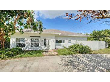 White house exterior with landscaping and a paved driveway at 1789 Loma Linda St, Sarasota, FL 34239