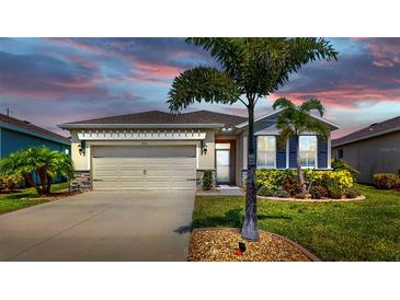 Charming single-story home featuring a two-car garage, complemented by a beautifully landscaped front yard at 3718 Mossy Limb Ct, Palmetto, FL 34221