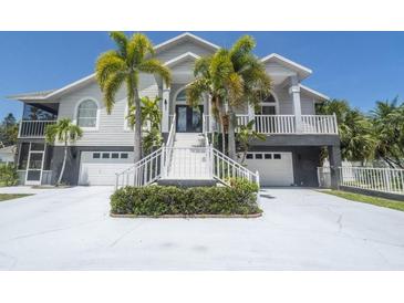 Two-story home with white siding and palm trees at 6317 Werner Ave, New Port Richey, FL 34652