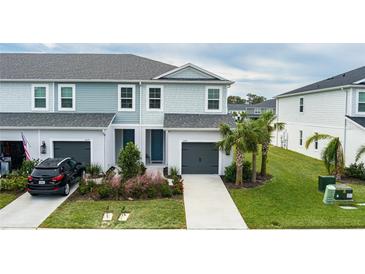 Two-story townhouses with attached garages and landscaping at 11655 Bluestone Ct, Parrish, FL 34219