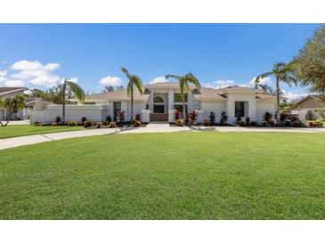 Modern house with palm trees and manicured lawn at 6817 Riverview Blvd, Bradenton, FL 34209