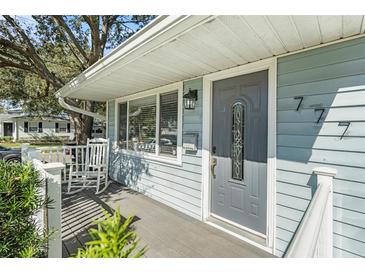 Inviting front porch with rocking chair and gray door at 777 51St N Ave, St Petersburg, FL 33703