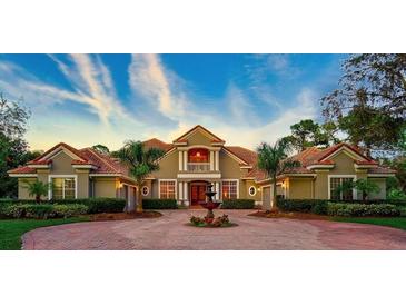 Grand two-story home with circular drive and fountain at 854 Macewen Dr, Osprey, FL 34229