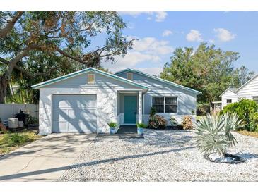 Charming light blue home with a stone facade and gravel driveway at 1105 58Th S St, Gulfport, FL 33707