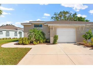 Front exterior of a light beige house with a garage at 146 51St Street E Cir, Palmetto, FL 34221