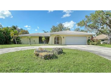 Single-story home with a large yard and attached garage at 134 Da Vinci Dr, Nokomis, FL 34275